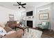 Comfortable living room with fireplace, ceiling fan, TV, plush seating, and decorative rug at 706 Great Ridge Pkwy, Chapel Hill, NC 27516