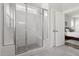 Tile shower with glass doors and built-in bench, with view into the bedroom at 706 Great Ridge Pkwy, Chapel Hill, NC 27516