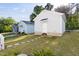 View of the lush yard and charming garage or accessory dwelling unit (ADU) exteriors at 706 Great Ridge Pkwy, Chapel Hill, NC 27516
