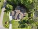 Aerial view of a well-maintained property with a pool, lush landscaping, and a neatly paved driveway at 7312 Hasentree Way, Wake Forest, NC 27587