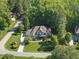Expansive property showcases lush greenery, a long driveway, and mature trees surrounding the residence at 7312 Hasentree Way, Wake Forest, NC 27587