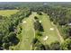 Aerial view of the golf course showcasing lush greenery, manicured fairways, and water features at 7312 Hasentree Way, Wake Forest, NC 27587