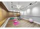 Finished basement featuring ample workout space and custom lighting at 7312 Hasentree Way, Wake Forest, NC 27587