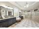 The primary bath offers double vanities, tiled floors, an ottoman, and a glass enclosed shower at 7312 Hasentree Way, Wake Forest, NC 27587