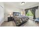 Cozy bedroom with a decorative duvet, side tables with lamps, and a window at 7312 Hasentree Way, Wake Forest, NC 27587