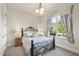 Charming bedroom showcases a wrought iron bed frame, side tables with lamps, and a window view at 7312 Hasentree Way, Wake Forest, NC 27587