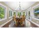 Bright breakfast nook featuring wood floors, skylights, many windows, and a wooden table at 7312 Hasentree Way, Wake Forest, NC 27587