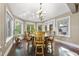 Bright breakfast nook with wood flooring, skylights, many windows, and a chandelier for elegant dining at 7312 Hasentree Way, Wake Forest, NC 27587