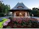 Charming entrance with beautiful stone structure and colorful landscaping at 7312 Hasentree Way, Wake Forest, NC 27587