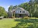 Well-manicured two-story home with lush landscaping and a large front lawn at 7312 Hasentree Way, Wake Forest, NC 27587