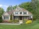 Charming two-story home featuring manicured landscaping and a welcoming front porch at 7312 Hasentree Way, Wake Forest, NC 27587