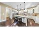 Bright and airy kitchen featuring an island with seating and stainless steel appliances at 7312 Hasentree Way, Wake Forest, NC 27587
