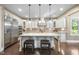 Gourmet kitchen featuring a large island, stainless steel appliances, and custom cabinetry at 7312 Hasentree Way, Wake Forest, NC 27587