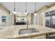 Bright kitchen island with granite countertop and seating, open to the living area at 7312 Hasentree Way, Wake Forest, NC 27587