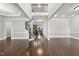 Open concept living room with hard wood floors, stairs, high ceilings, and views of a brick fireplace at 7312 Hasentree Way, Wake Forest, NC 27587