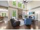 Spacious living area with a stone fireplace, hardwood floors, and bright natural light at 7312 Hasentree Way, Wake Forest, NC 27587