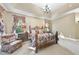 The main bedroom features a trey ceiling, carpet, a decorative bed frame and windows at 7312 Hasentree Way, Wake Forest, NC 27587