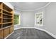 Bright office space with built-in shelving and large windows overlooking the backyard at 7312 Hasentree Way, Wake Forest, NC 27587