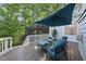 Charming deck with blue patio furniture and a serene wooded view at 7312 Hasentree Way, Wake Forest, NC 27587