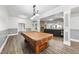 Spacious recreation room features a pool table, stone fireplace, and comfortable seating area at 7312 Hasentree Way, Wake Forest, NC 27587