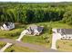 Aerial showcases a luxurious home with lush landscaping, set within a peaceful and private wooded neighborhood at 8017 Discovery Falls Trl, Wake Forest, NC 27587