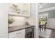 The stylish bar area features a wine fridge, custom cabinetry, and elegant finishes at 8017 Discovery Falls Trl, Wake Forest, NC 27587
