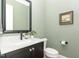 The elegant powder room boasts a marble vanity, stylish fixtures, and modern decor at 8017 Discovery Falls Trl, Wake Forest, NC 27587