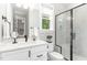 Bright bathroom with a glass-enclosed shower, white vanity, and natural light at 8017 Discovery Falls Trl, Wake Forest, NC 27587