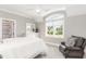 Bedroom features an arched window, a ceiling fan, and carpeted floor at 8017 Discovery Falls Trl, Wake Forest, NC 27587