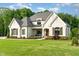 Charming two-story white brick home featuring manicured landscaping and a welcoming front porch at 8017 Discovery Falls Trl, Wake Forest, NC 27587