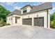 Spacious three-car garage with modern doors and a well-maintained concrete driveway at 8017 Discovery Falls Trl, Wake Forest, NC 27587