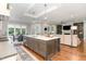 A view of this open-concept kitchen reveals a large island, pendant lighting, and seamless flow into the living areas at 8017 Discovery Falls Trl, Wake Forest, NC 27587