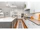This spacious kitchen features stainless steel appliances, a large island with a sink, and stylish white cabinetry at 8017 Discovery Falls Trl, Wake Forest, NC 27587