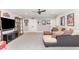 Living room featuring a sectional sofa, large TV, and wall decorations at 8017 Discovery Falls Trl, Wake Forest, NC 27587