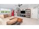 Living room with a comfortable sectional sofa and lots of entertainment options at 8017 Discovery Falls Trl, Wake Forest, NC 27587