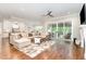 The comfortable living room boasts hardwood floors and seamless access to the kitchen and outdoor spaces at 8017 Discovery Falls Trl, Wake Forest, NC 27587