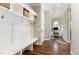 Inviting mudroom area with built-in storage bench and shelving; office space visible in background at 8017 Discovery Falls Trl, Wake Forest, NC 27587
