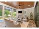 The relaxing covered patio features comfortable seating, a fireplace, and scenic views at 8017 Discovery Falls Trl, Wake Forest, NC 27587