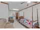 Bedroom featuring a ceiling fan, a bed, and a sofa at 9108 Ransdell Rd, Raleigh, NC 27603