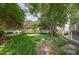 Spacious backyard featuring a lawn, mature trees for shade, and a well-maintained wooden deck at 9251 Palm Bay Cir, Raleigh, NC 27617
