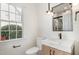 Bathroom featuring modern vanity with marble countertop, sleek fixtures and natural light at 9251 Palm Bay Cir, Raleigh, NC 27617