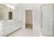 Bathroom with double vanity, walk-in closet, and glass enclosed shower at 9251 Palm Bay Cir, Raleigh, NC 27617