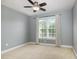A serene bedroom with light blue walls, plush carpet, and bright window for natural light at 9251 Palm Bay Cir, Raleigh, NC 27617