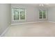 Bedroom featuring neutral walls, carpeted floors and two windows for natural lighting at 9251 Palm Bay Cir, Raleigh, NC 27617