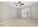 Comfortable carpeted bedroom with a ceiling fan and a large window with blinds at 9251 Palm Bay Cir, Raleigh, NC 27617