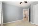Bedroom with neutral walls, carpet, and ceiling fan creates a clean and welcoming space at 9251 Palm Bay Cir, Raleigh, NC 27617