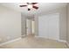 Bedroom features neutral carpet, ceiling fan, and closet, offering a cozy and functional space at 9251 Palm Bay Cir, Raleigh, NC 27617