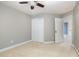 Bedroom with neutral walls, ceiling fan, carpet, and spacious closet offers functionality at 9251 Palm Bay Cir, Raleigh, NC 27617