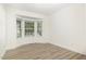 Bright, airy room featuring wood floors, white trim, and a bay window for plenty of natural light at 9251 Palm Bay Cir, Raleigh, NC 27617