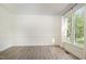 Bright, airy room with beautiful wood floors, white trim, and a large window for ample natural light at 9251 Palm Bay Cir, Raleigh, NC 27617